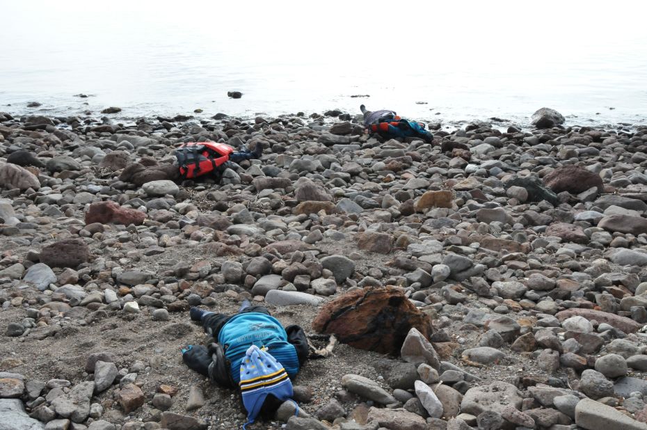 The bodies of migrants are seen on a beach after the boat capsized in the Aegean Sea. Authorities report that at least five children were among the dead. 
