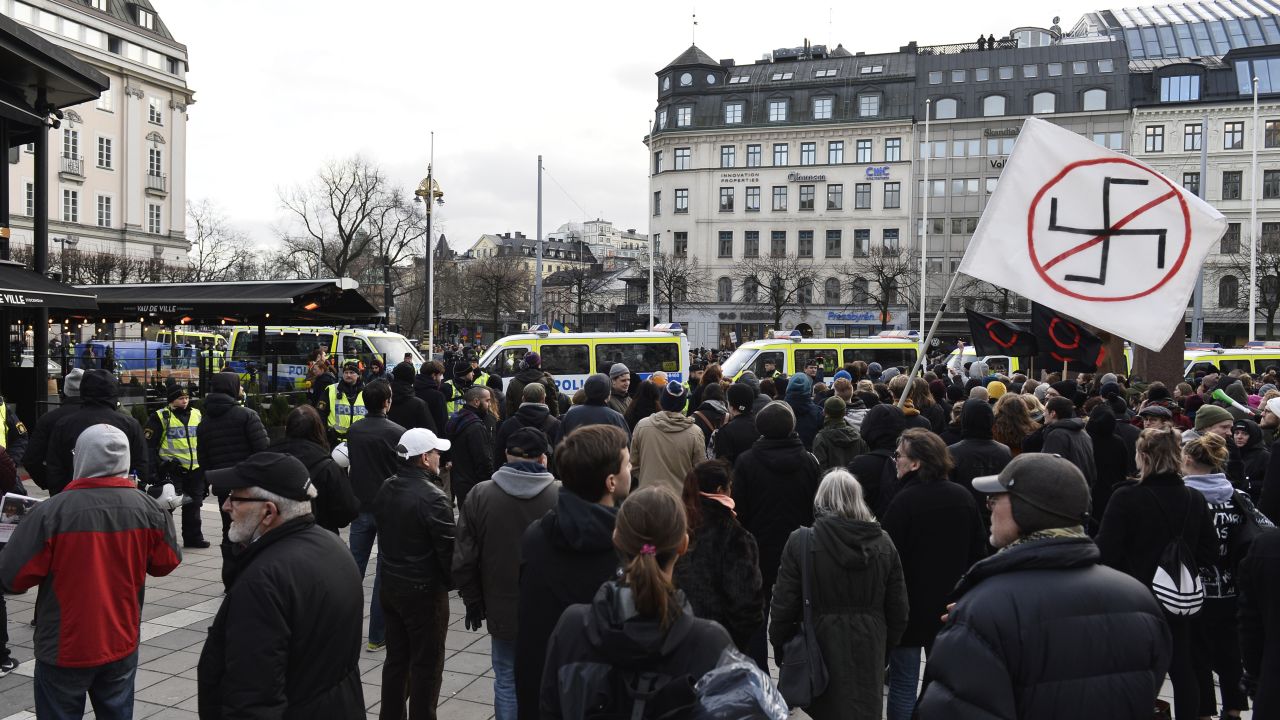 Protesters gather Saturday in Stockholm to show their disapproval of an anti-immigrant group's actions.