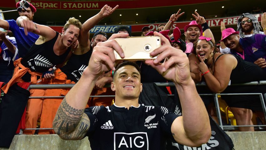 TOPSHOT - New Zealand's Sonny Bill Williams takes a selfie with fans during the cup final against South Africa on the second day of the Wellington Sevens rugby Union tournament at Westpac Stadium in Wellington on January 31, 2016. AFP PHOTO / MARTY MELVILLE / AFP / Marty Melville        (Photo credit should read MARTY MELVILLE/AFP/Getty Images)