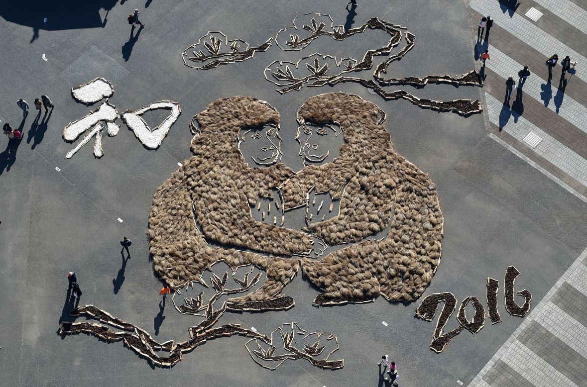 Visitors at the Hitachi Seaside Park in Hitachinaka, Japan, check out a display of two monkeys on Sunday, January 3. The display was made up of about 15,000 pine cones and plants collected in the park.
