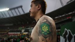 An Ultra supporter of the Beijing Guoan FC shows a tattoo of the teams logo during a match against Chongcing Lifan FC in Chinese Super League play on June 28, 2015 in Beijing, China. There are growing legions of ardent supporters and fans of China's football clubs. The government is also trying to foster a football culture in the country by mandating football programs in 20,000 Chinese schools in a recent plan devised by President Xi Jinping to make China a football power. (Photo by Kevin Frayer/Getty Images)