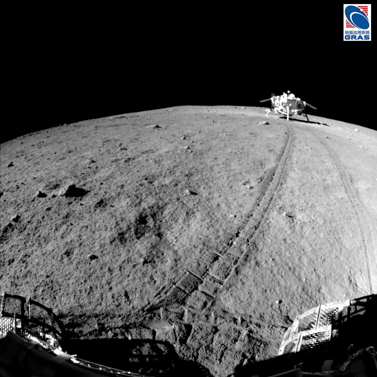 The tracks of the Jade Rabbit lunar rover, with the Chang'e 3 spacecraft in the background. 