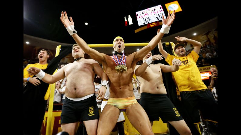 Legendary swimmer Michael Phelps helps Arizona State students try to distract a free-throw shooter during a college basketball game on Thursday, January 28. The Oregon State shooter missed both of his shots after Phelps popped out of the "Curtain of Distraction." <a href="http://bleacherreport.com/articles/2612010-michael-phelps-pops-out-of-asus-curtain-of-distraction-to-distract-ft-shooter" target="_blank" target="_blank">Watch the video</a>