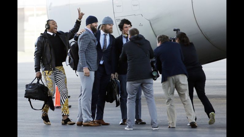 Carolina Panthers quarterback Cam Newton, left, jumps into a picture with Derek Anderson, Greg Olsen and Luke Kuechly after the Super Bowl-bound team arrived in San Jose, California, on Sunday, January 31.