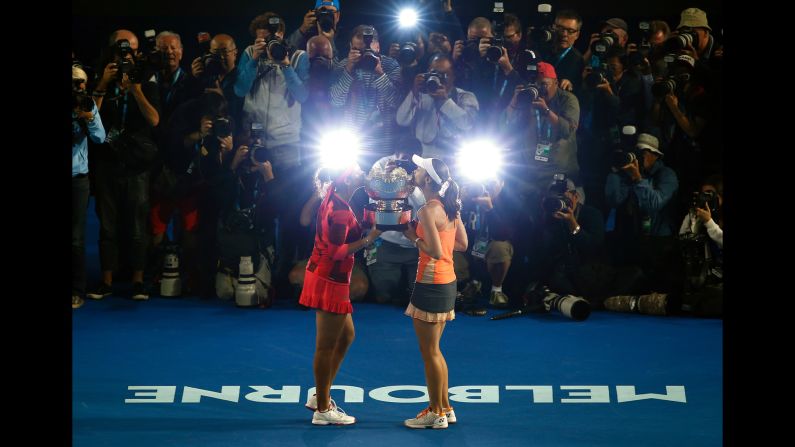Sania Mirza, left, and Martina Hingis kiss their trophy after they won the doubles title at the Australian Open on Friday, January 29. Last year, the team won Wimbledon and the U.S. Open.