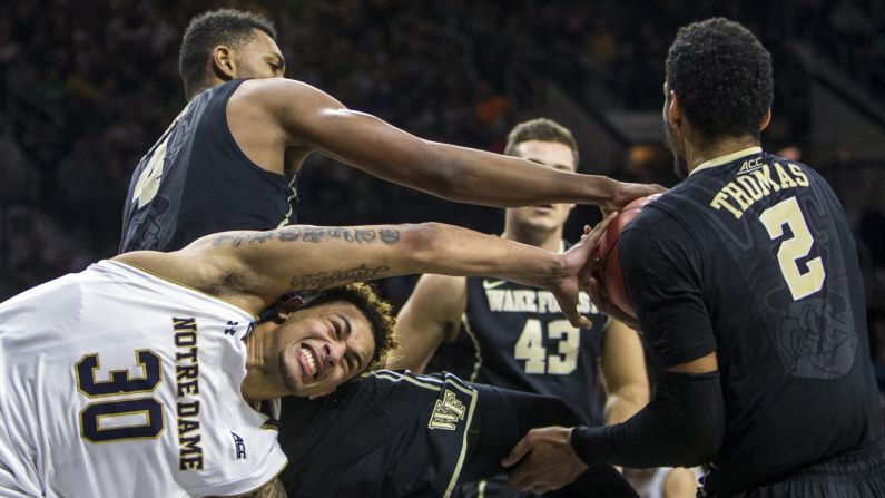 Wake Forest players steal the ball from Notre Dame's Zach Auguste during a college basketball game in South Bend, Indiana, on Sunday, January 31. 