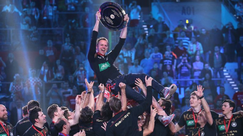 Germany head coach Dagur Sigurdsson is lifted by his players Sunday, January 31, after they won the European Handball Championship in Krakow, Poland. The Germans defeated Spain in the final to win their first European title since 2004.