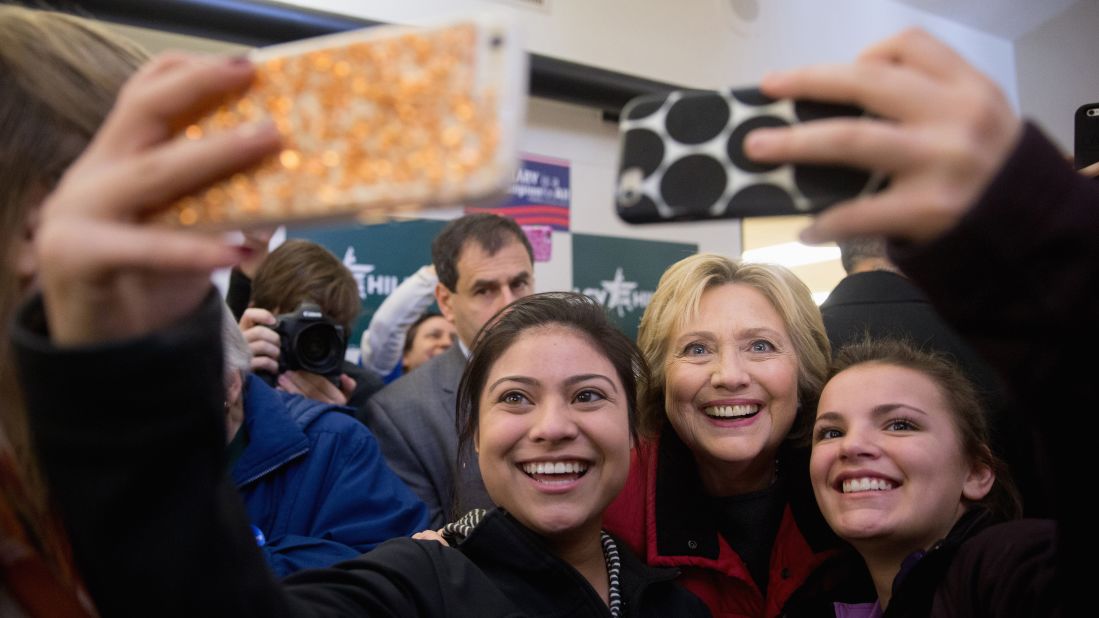 Clinton poses for selfies at her campaign office in Des Moines.