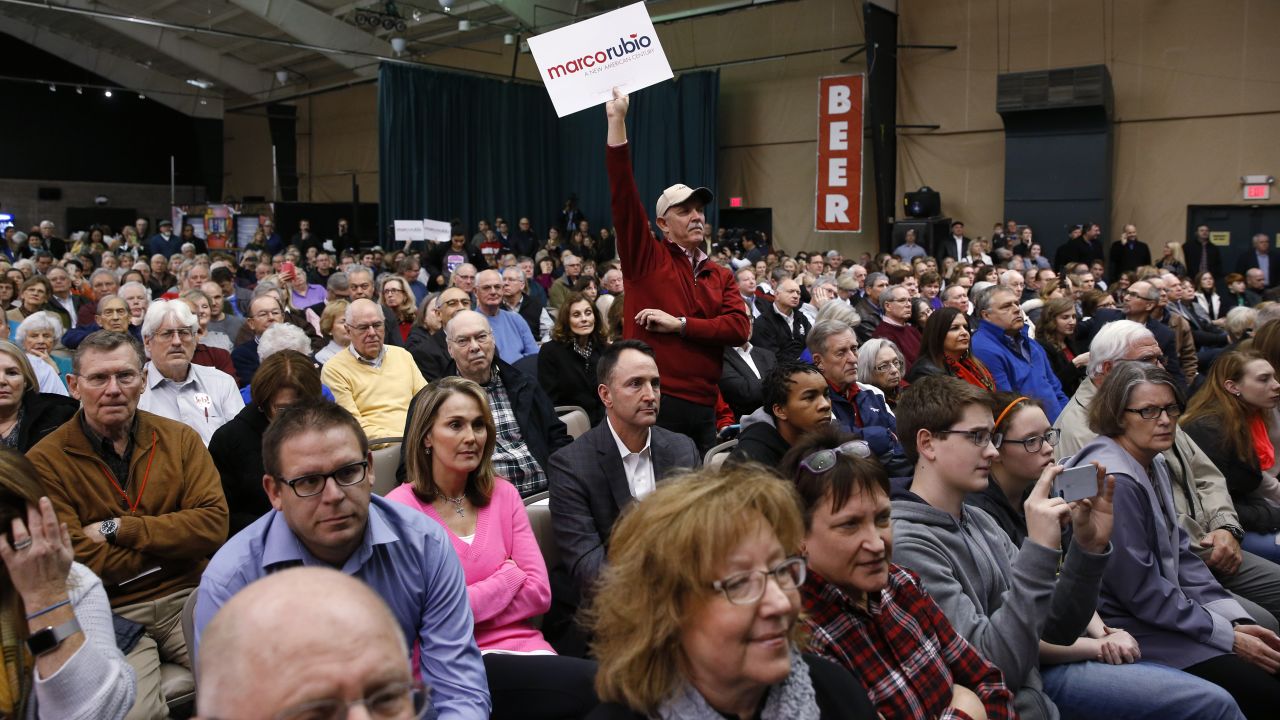 A Rubio supporter holds a sign at a caucus site in Clive, Iowa.