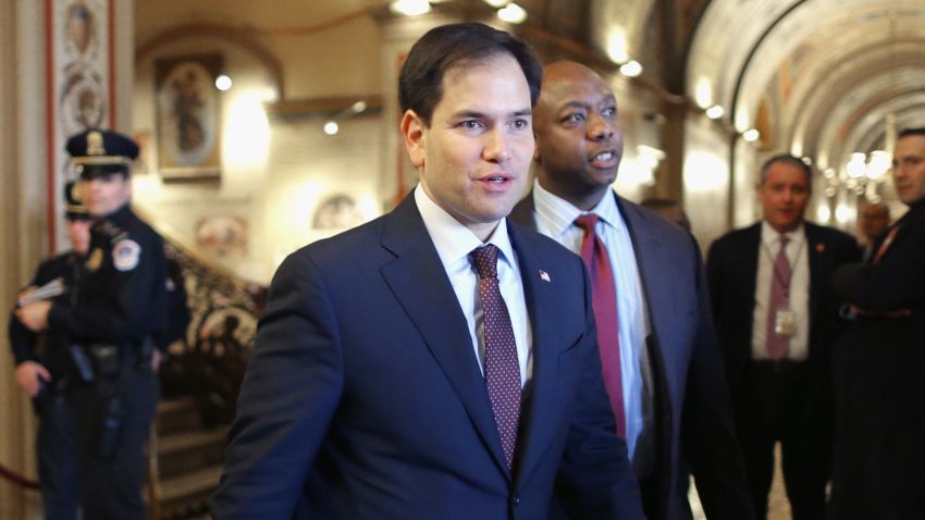 U.S. Sen. Marco Rubio (R-FL) (L) and Sen. Tim Scott (R-SC) walk thorugh the U.S. Capitol February 12, 2014 in Washington, DC.