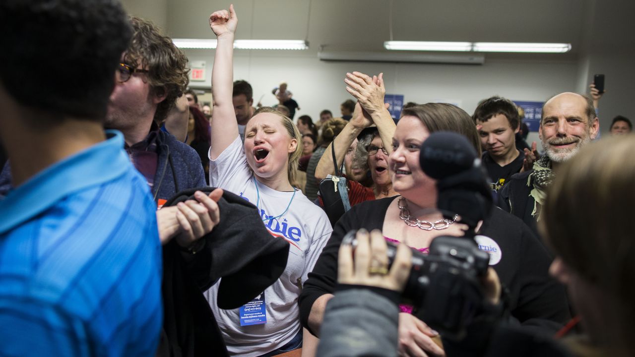 A Sanders supporter celebrates caucus results at a Des Moines precinct.