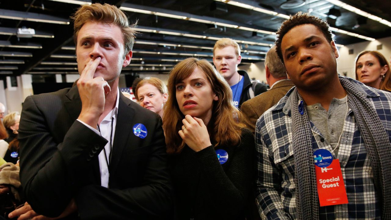 Clinton supporters in Des Moines watch the television as caucus results roll in.
