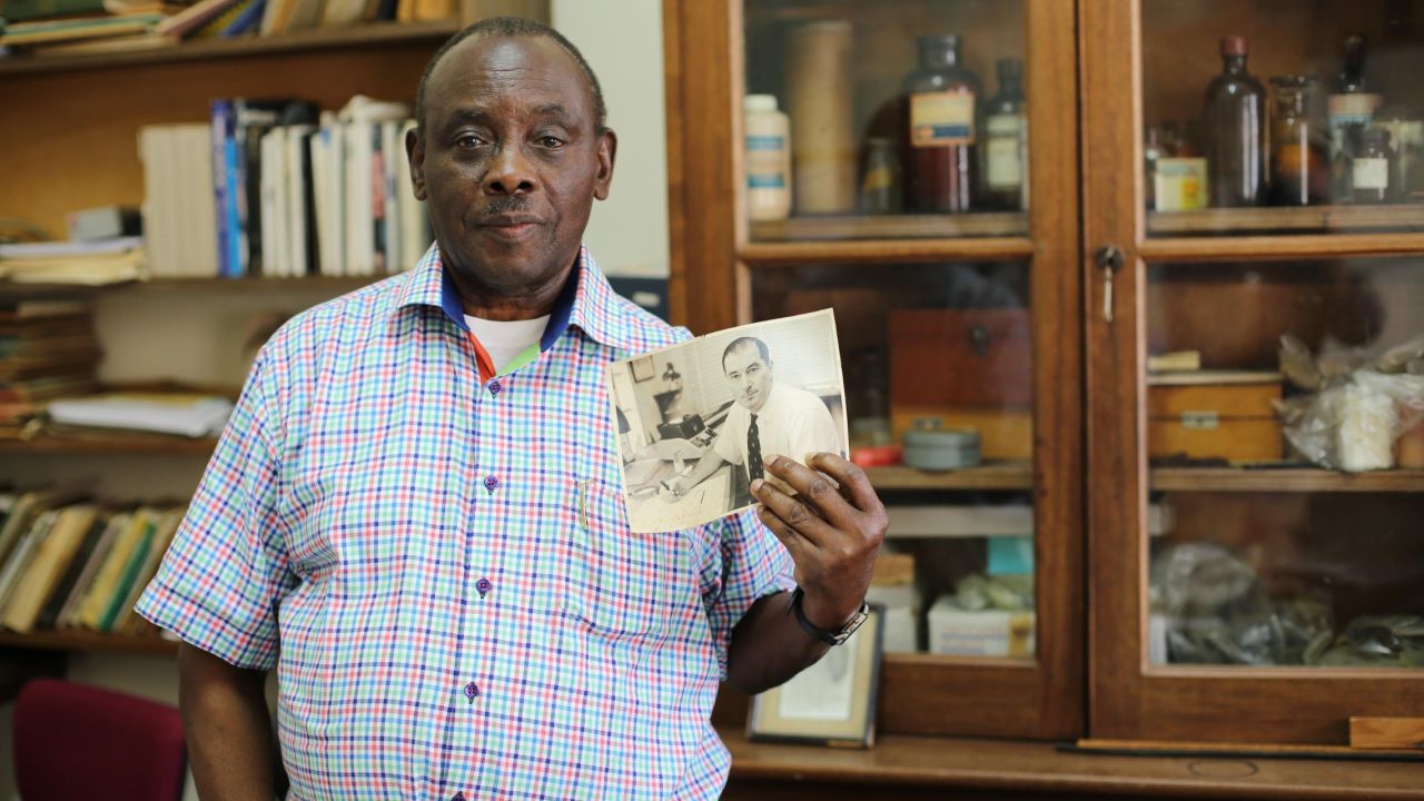 Entomologist Louis Mukwaya holds a picture of Alexander Haddow, the scientist who first identified Zika virus in 1947. "He was a very hardworking man," Mukwaya said of Haddow. Mukwaya has been working at the institute since 1965.