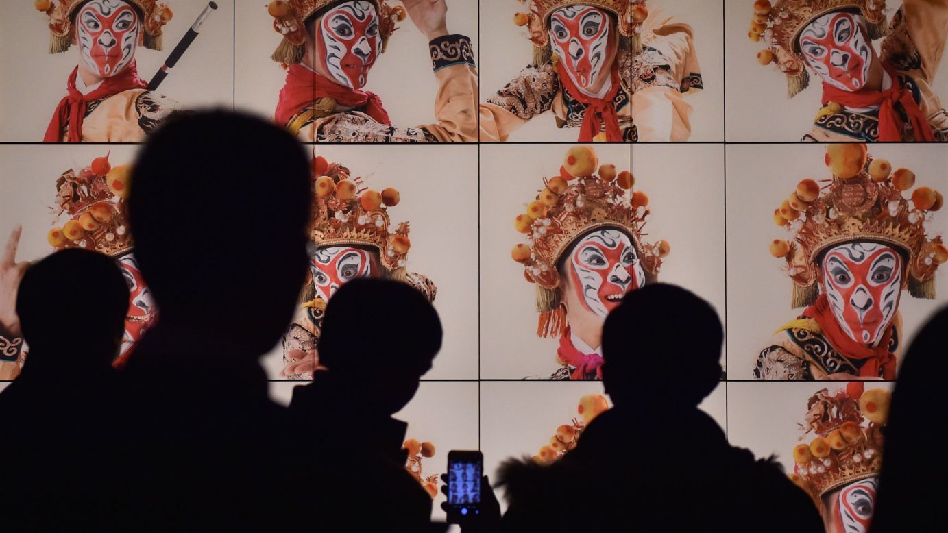 Visitors view pictures at the Capital Museum in Beijing on Monday, February 1. Nearly 60 pieces of art featuring monkey figures were on display.