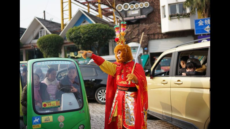 Security personnel dressed as the Monkey King gives directions to tourists in Chongqing, China, on February 2.