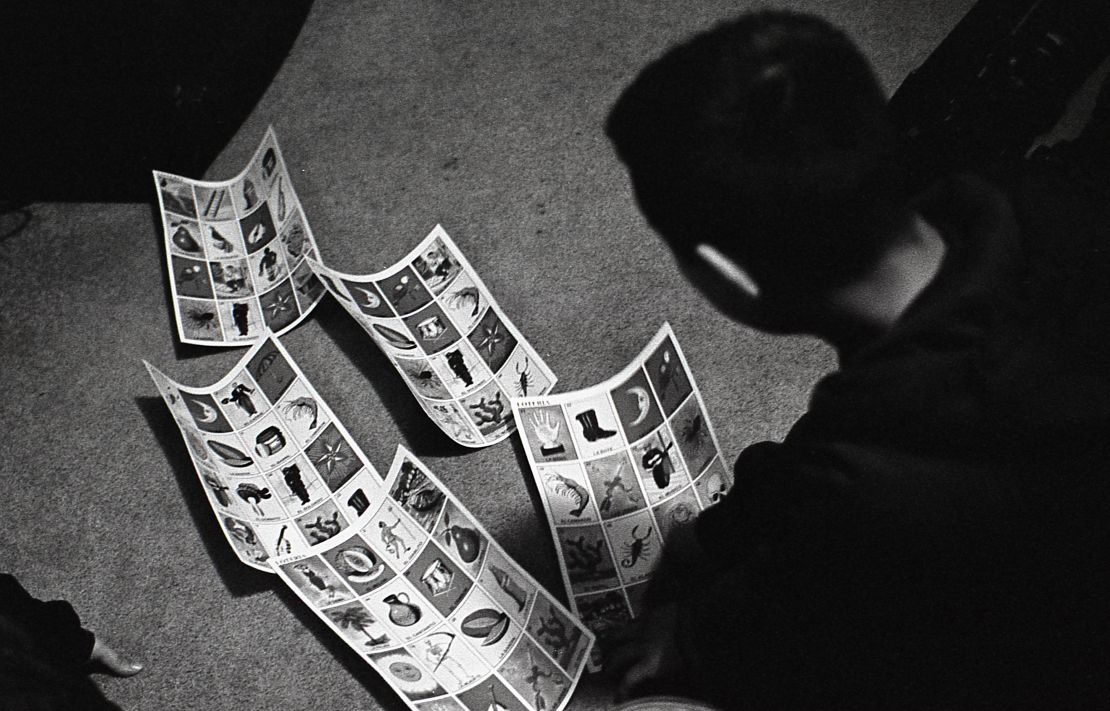 Jesús searches for the lucky cards in his family's Lotería game.