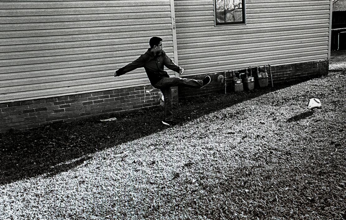 Jesús plays soccer after school while his parents rest during an afternoon break before returning to work.