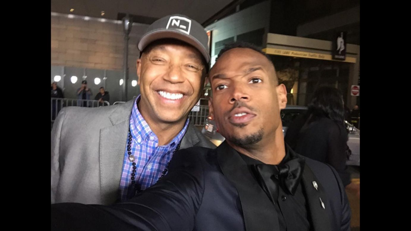 Hip-hop mogul Russell Simmons, left, <a href="https://www.instagram.com/p/BBDD45eujUT/" target="_blank" target="_blank">poses with actor Marlon Wayans</a> as he attends the "Fifty Shades of Black" premiere on Tuesday, January 26.