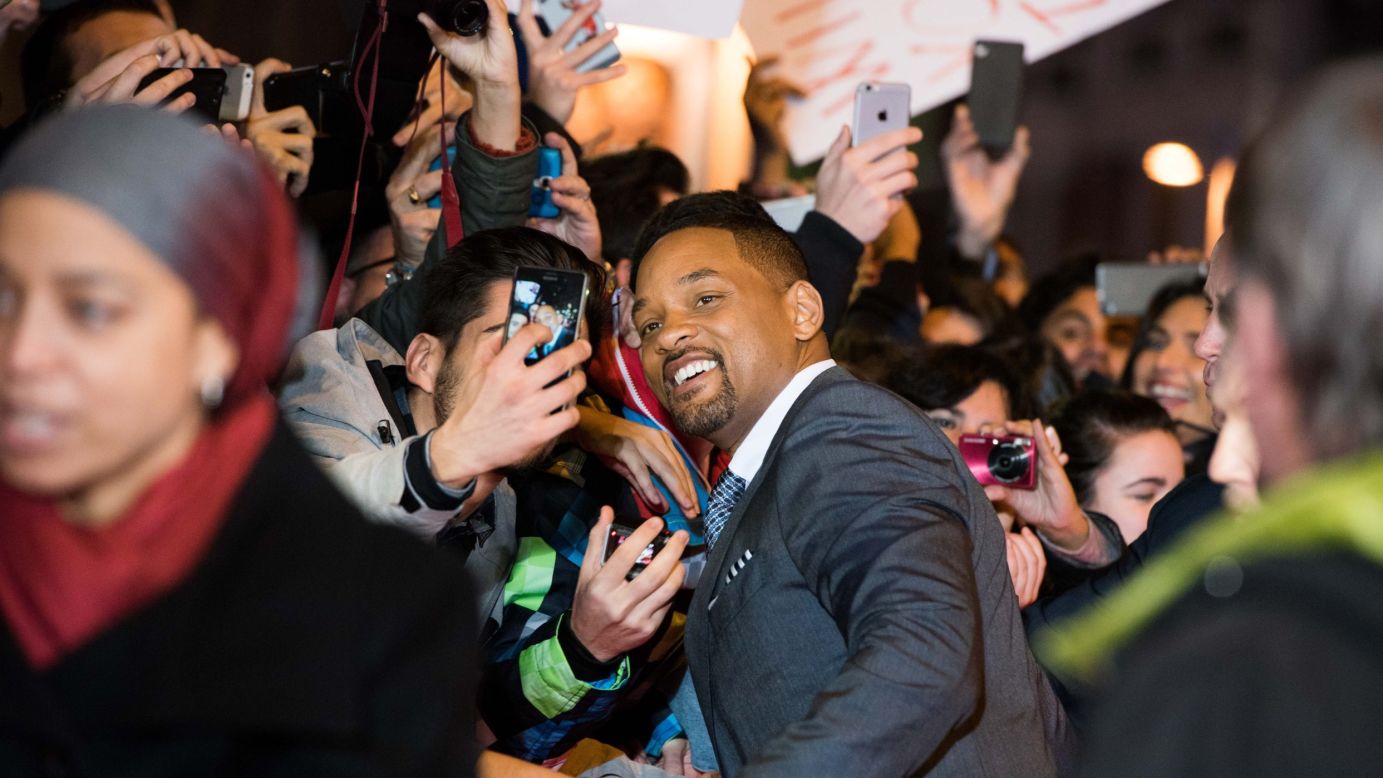 A fan gets a selfie with actor Will Smith at the "Concussion" premiere in Madrid on Wednesday, January 27.
