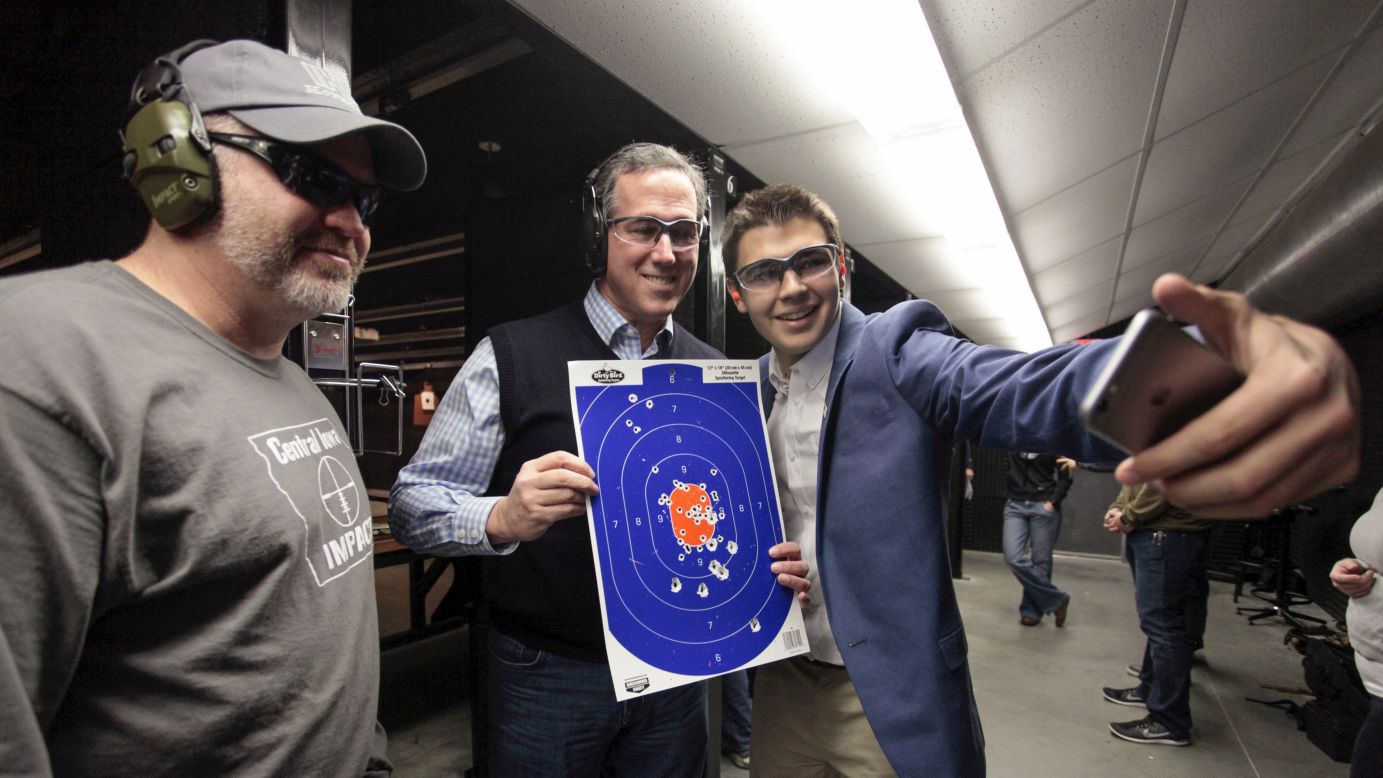 Republican presidential candidate Rick Santorum, second from right, poses for a selfie at a shooting range in Boone, Iowa, on Saturday, January 30.
