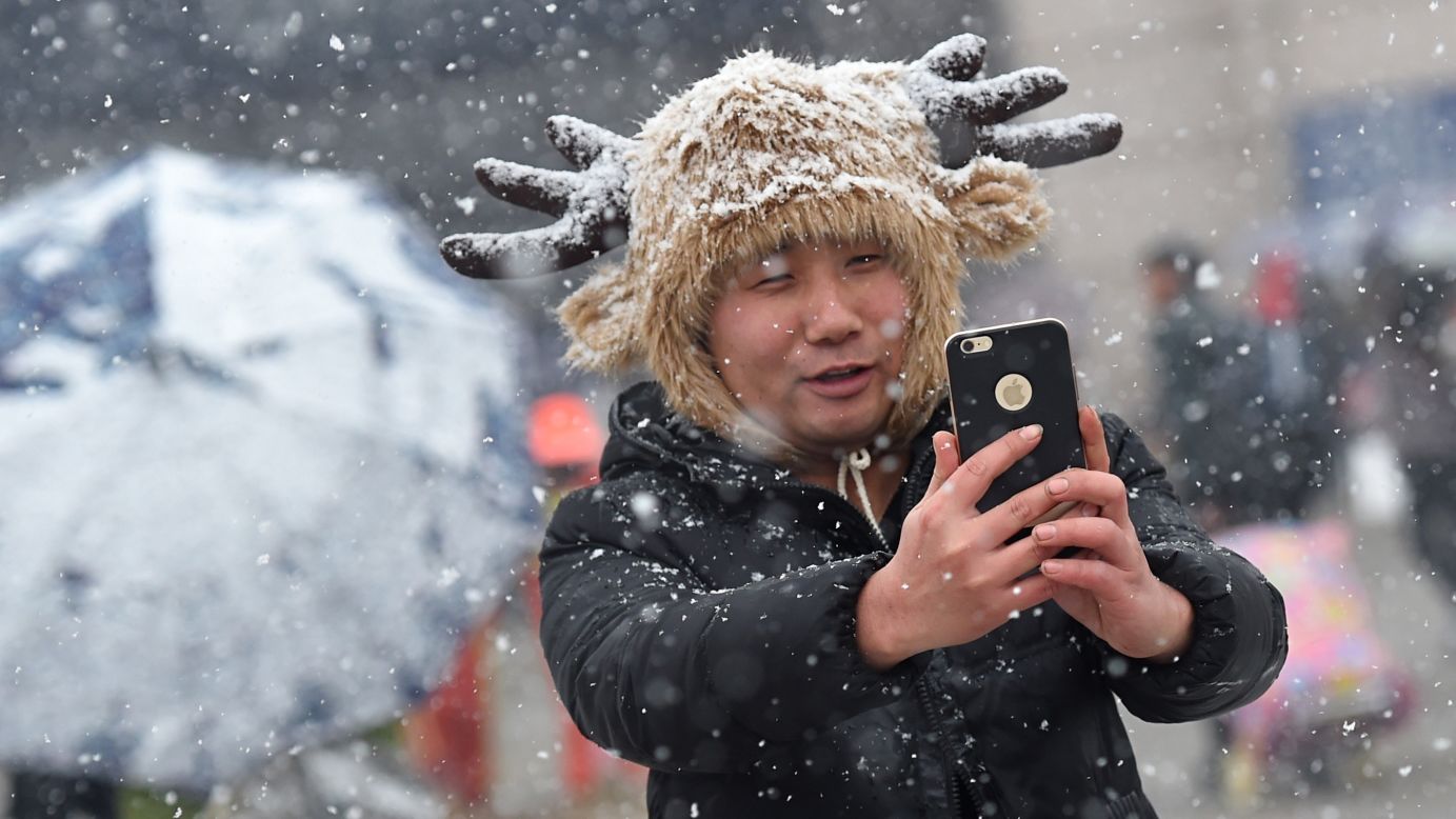 A traveler takes selfies in the show at a railway station in Wuhan, China, on Sunday, January 31. <a href="http://www.cnn.com/2016/01/27/living/gallery/look-at-me-selfies-0127/index.html" target="_blank">See 21 selfies from last week</a>