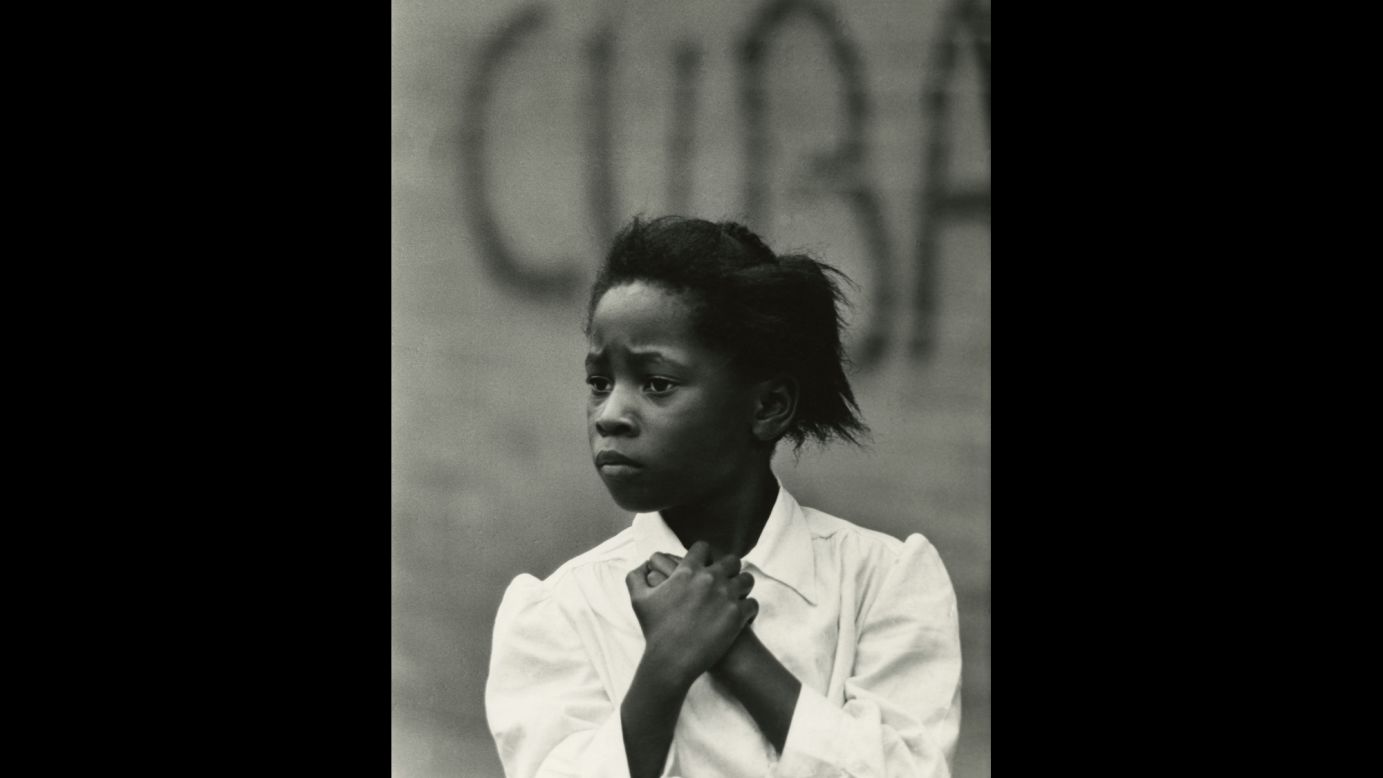 One of Draper's recurring themes was the juxtaposition of human subjects with street signs, posters or graffiti. This image, "Girl and Cuba," was captured in Philadelphia in 1968.