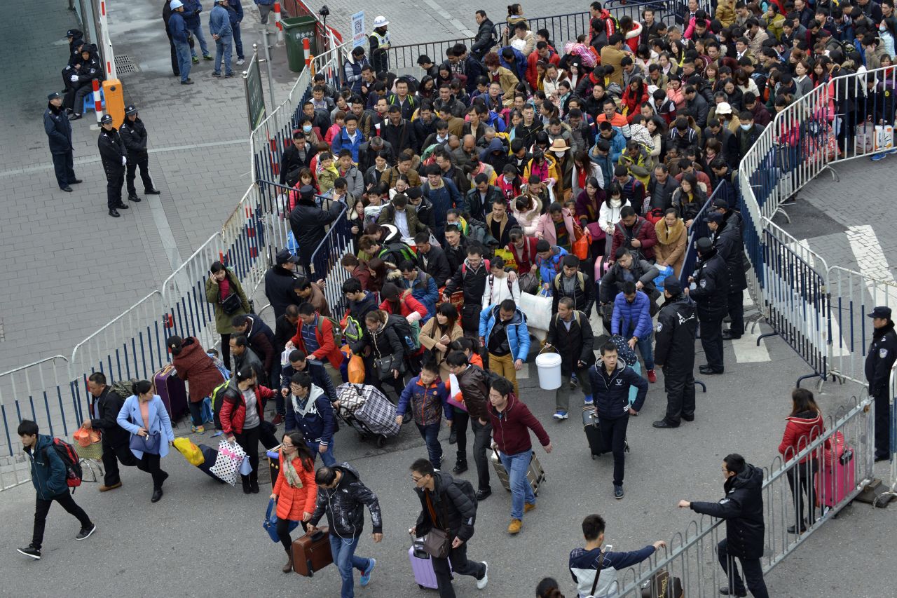 Passengers queue up to enter Guangzhou railway station on February 2, with some "on the front line" seen breaking into a run.
