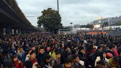 This picture taken on February 1, 2016 shows huge queues outside Guangzhou railway station in Guangzhou, in southern China's Guangdong province.  Tens of thousands of Lunar New Year travelers in China were stranded on February 2 at a station in Guangzhou, state media said, after snow and ice elsewhere disrupted the world's largest annual human migration.