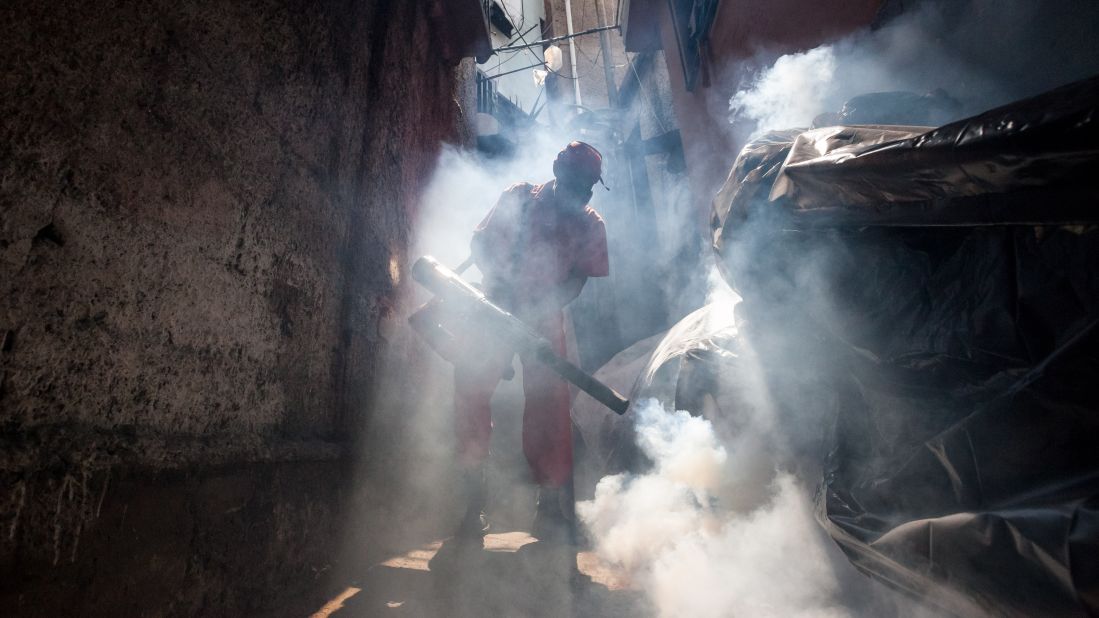 A health worker fumigates an area in Caracas, Venezuela, on Tuesday, February 2. 