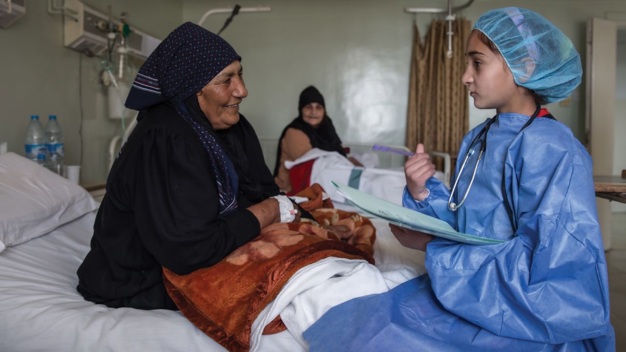 "In this image, I am in the future and a well-respected physician at a major hospital in Syria. I am asking a patient about her pain and helping her to get better. My mother was born and raised in a village and didn't go to school, but as a young girl, I had the opportunity to learn and grow into a great doctor."