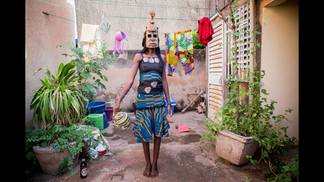 Judith, 22, wears a mask of fertility from the Dogon ethnic group. She's a student in Ivory Coast who dreams of a career as a model, Harbi said.