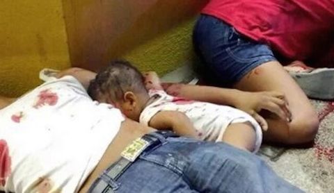 The picture of a 7-month-old baby lying dead on a sidewalk between his parents has caused fury in Mexico.