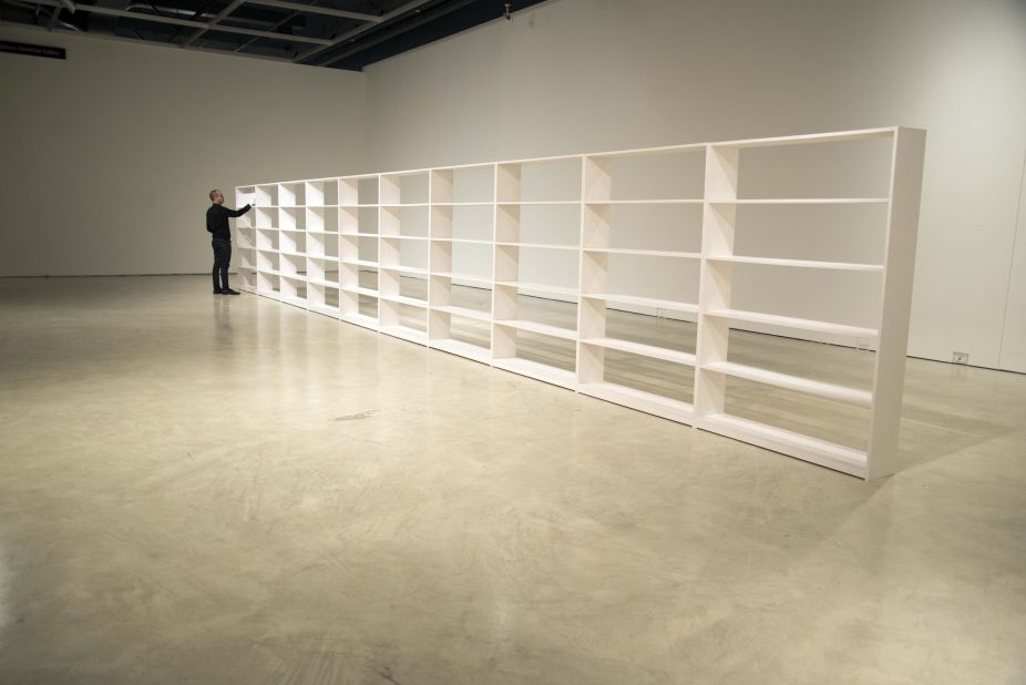 For this installation, he has created a forty foot long all white bookshelf. 