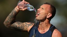 SYDNEY, AUSTRALIA - AUGUST 28:  Quade Cooper of the Wallabies drinks water during an Australian Wallabies training session at Little Manly Beach on August 28, 2015 in Sydney, Australia.  (Photo by Brendon Thorne/Getty Images)