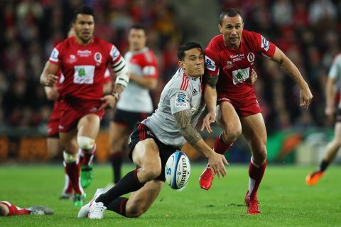 Cooper is close friends with New Zealand rugby star Sonny Bill Williams. Here they compete for the ball during the 2011 Super Rugby final between the Reds and the Crusaders.