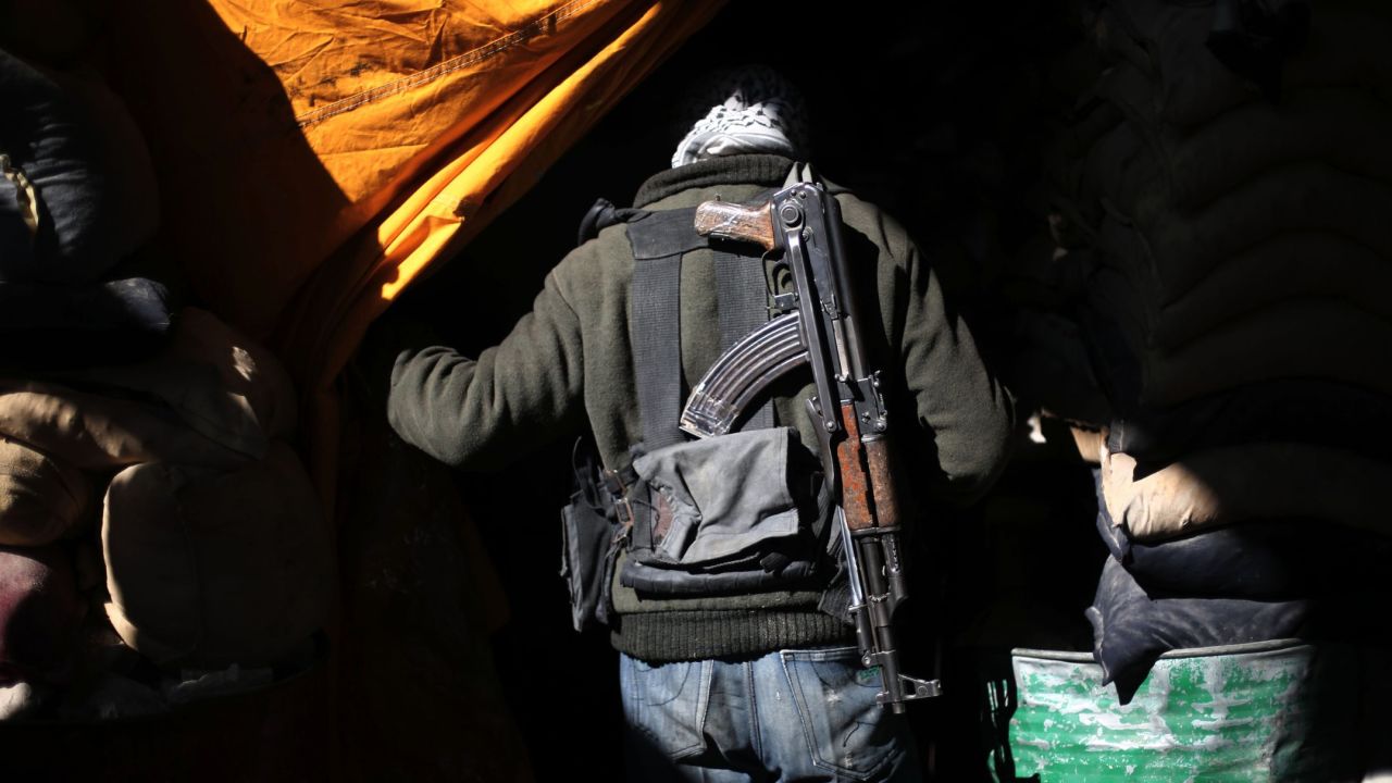 A Syrian rebel fighter walks past sandbags in Arbin, Syria, on Friday, January 29.