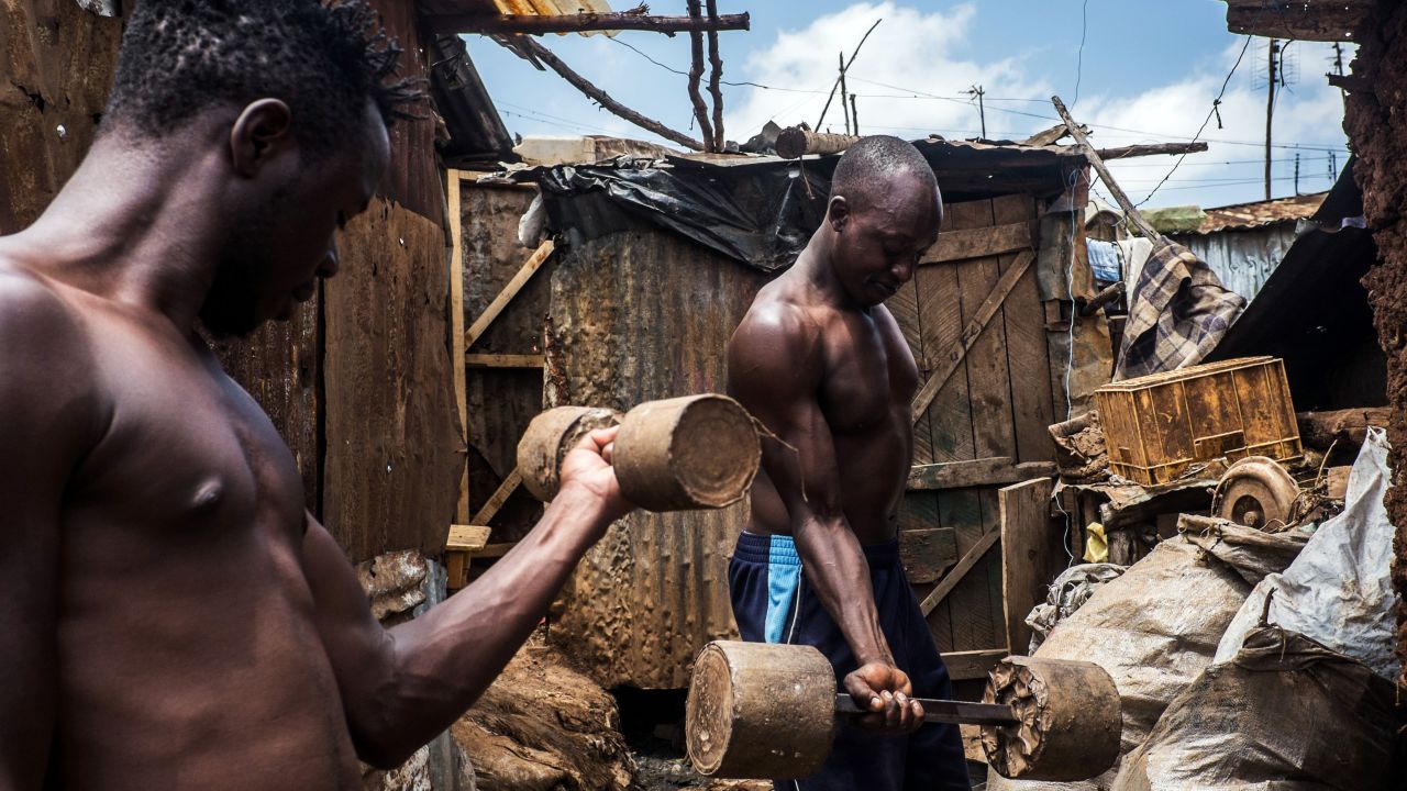 Men lift homemade weights at a slum in Nairobi, Kenya, on Tuesday, February 2.