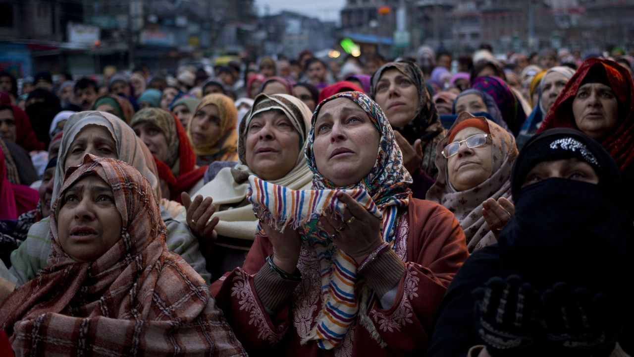 Kashmiri Muslims in Srinigar, India, pray outside the shrine of Sufi saint Syed Abdul Qadir Jilani on Friday, January 29. The saint's relics were being displayed at the shrine.