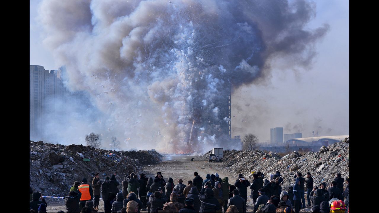 People watch police destroy confiscated firecrackers in Shenyang, China, on Friday, January 29.