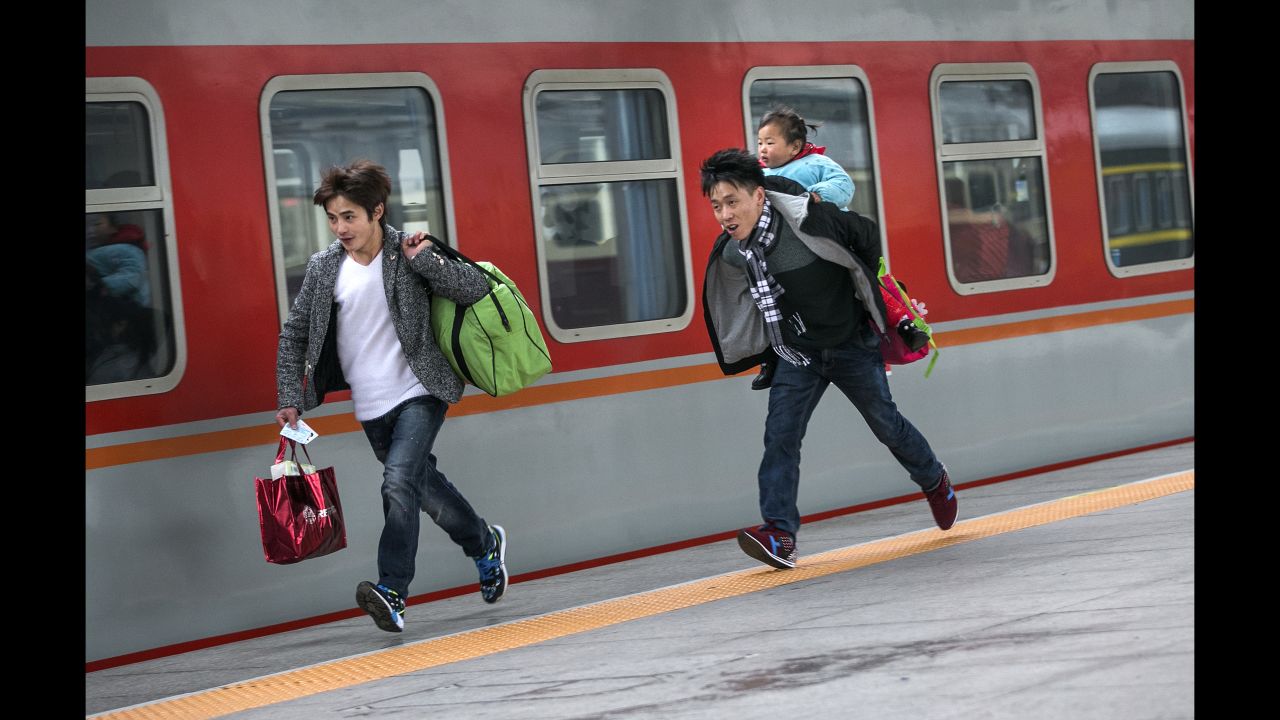 Travelers run to catch a train in Hangzhou, China, on Sunday, January 31. China's annual <a href="http://www.cnn.com/2015/02/17/travel/china-spring-migration-chunyun/index.html" target="_blank">Spring Festival migration</a> started on January 24. It's expected that 2.9 billion trips will be made during the holiday period this year.