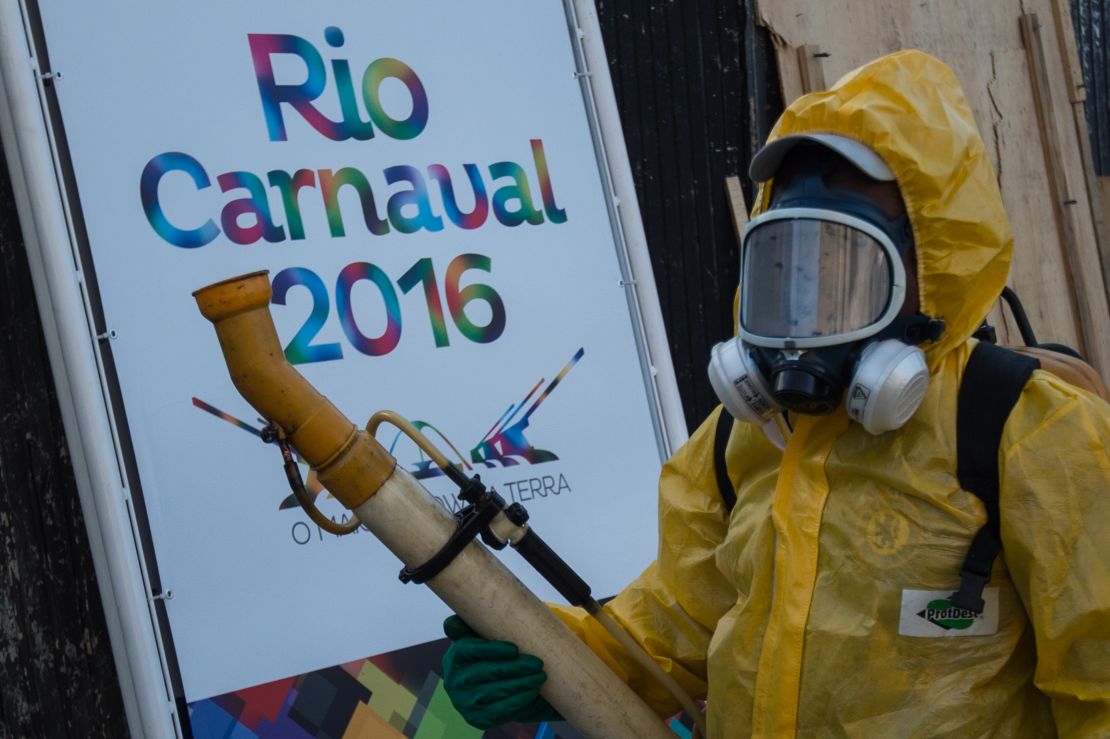 A municipal agent sprays mosquito repellent chemicals in Rio de Janeiro.