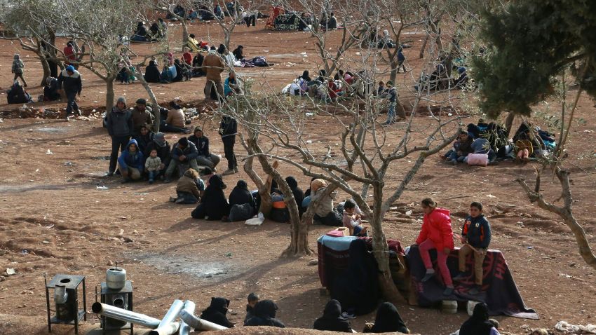 Syrians fleeing Aleppo wait in a field in the town of Iqda, Syria, on Friday, February 5.