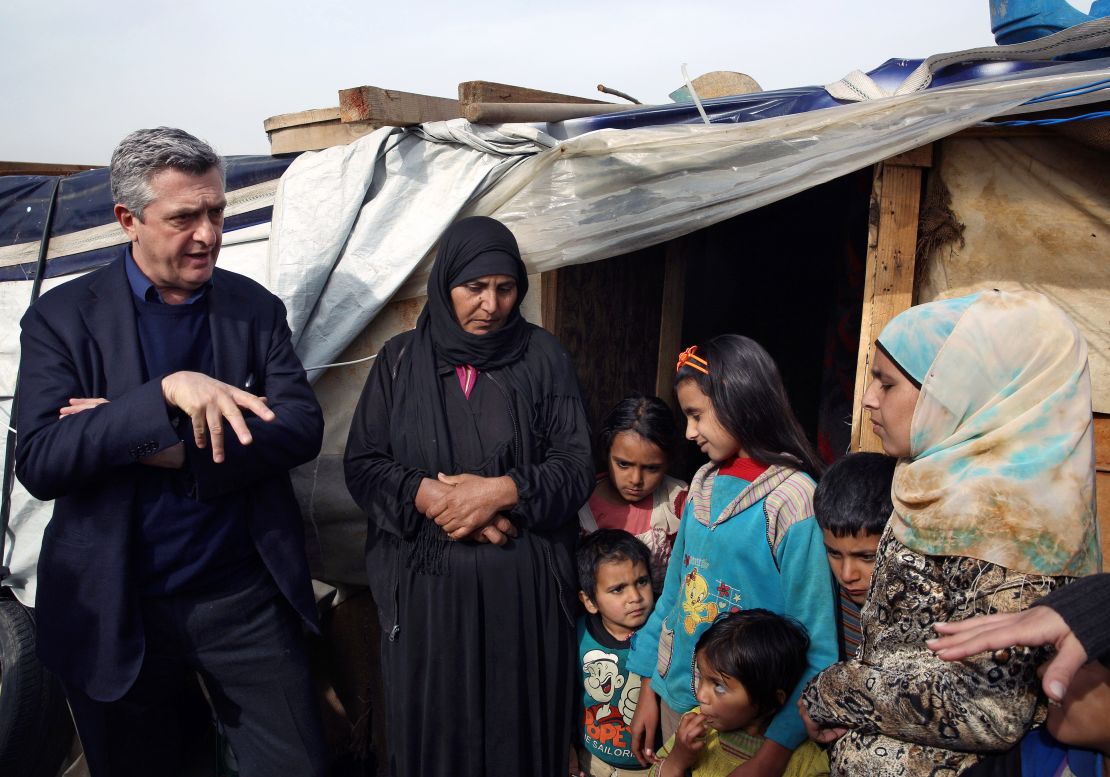 U.N. High Commissioner for Refugees Filippo Grandi speaks with a Syrian family outside their tent in Saadnayel, Lebanon, in the Bekaa Valley, on January 22.