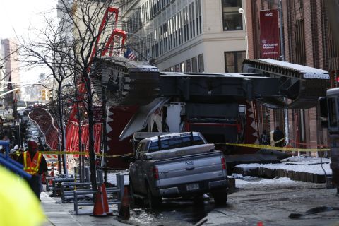 A construction crane lies on a street in Lower Manhattan.