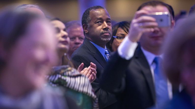 Republican presidential candidate Ben Carson and his wife Candy Carson stand up to applaud the arrival of President Barack Obama and first lady Michelle Obama at the National Prayer Breakfast in Washington on Thursday, February 4.