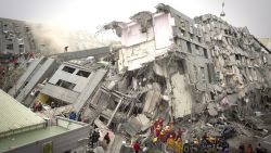 TAINAN, TAIWAN - FEBRUARY 06:  Rescue personnel search for survivors at the site of a collapsed building on February 6, 2016 in Tainan, Taiwan. A magnitude 6.4 earthquake hit southern Taiwan early Saturday, toppling several buildings and killing at least two people in Tainan, according to local news reports.  (Photo by Ashley Pon/Getty Images)