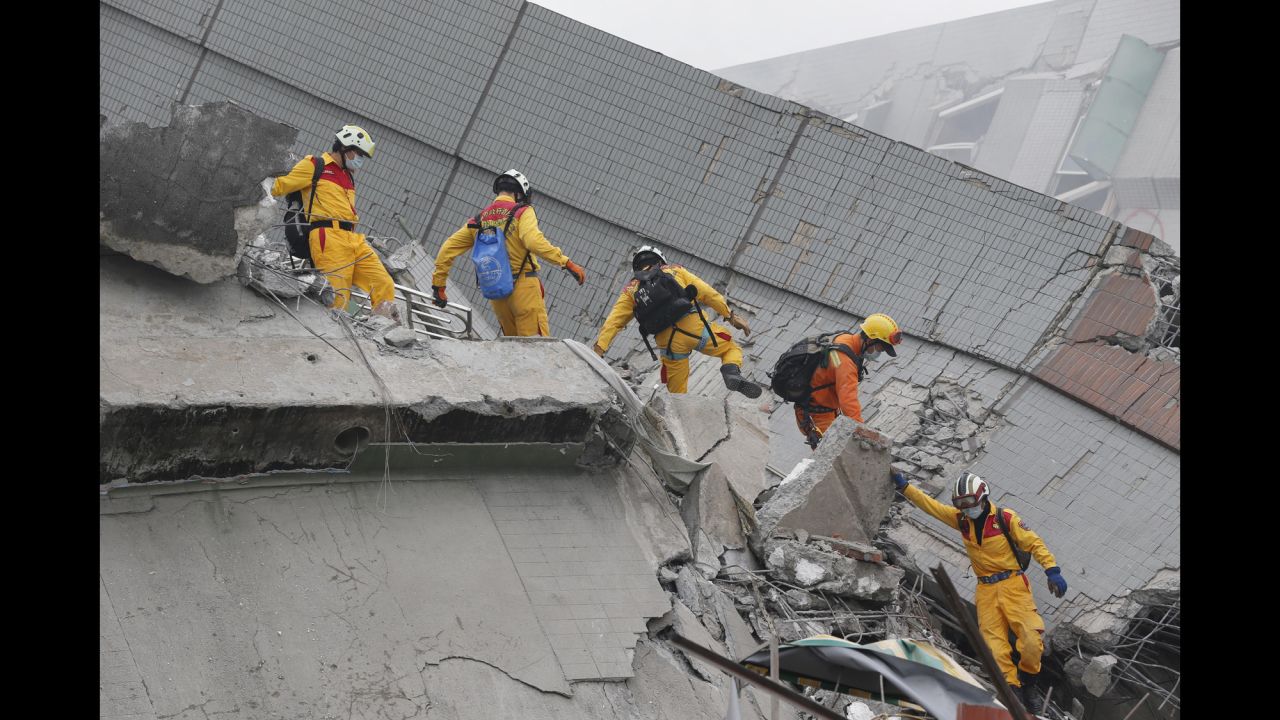 Rescue workers search a collapsed building in Tainan.