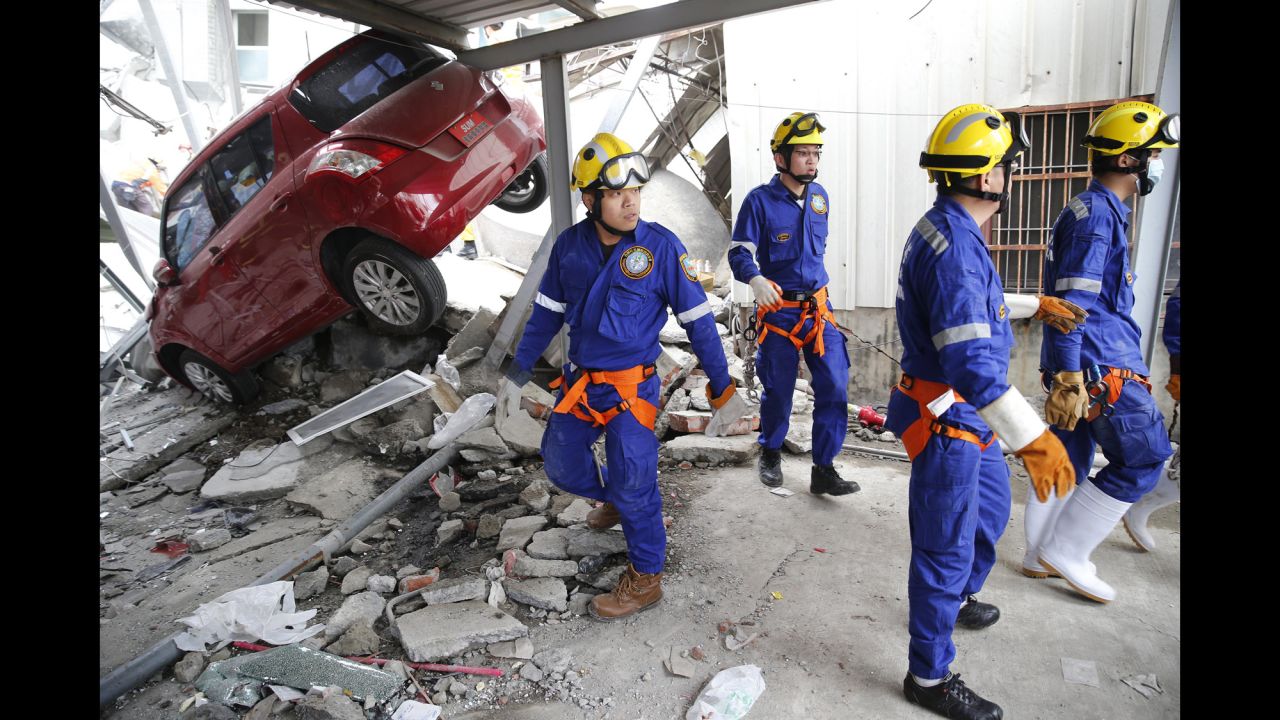 Rescue workers search a collapsed building in Tainan.