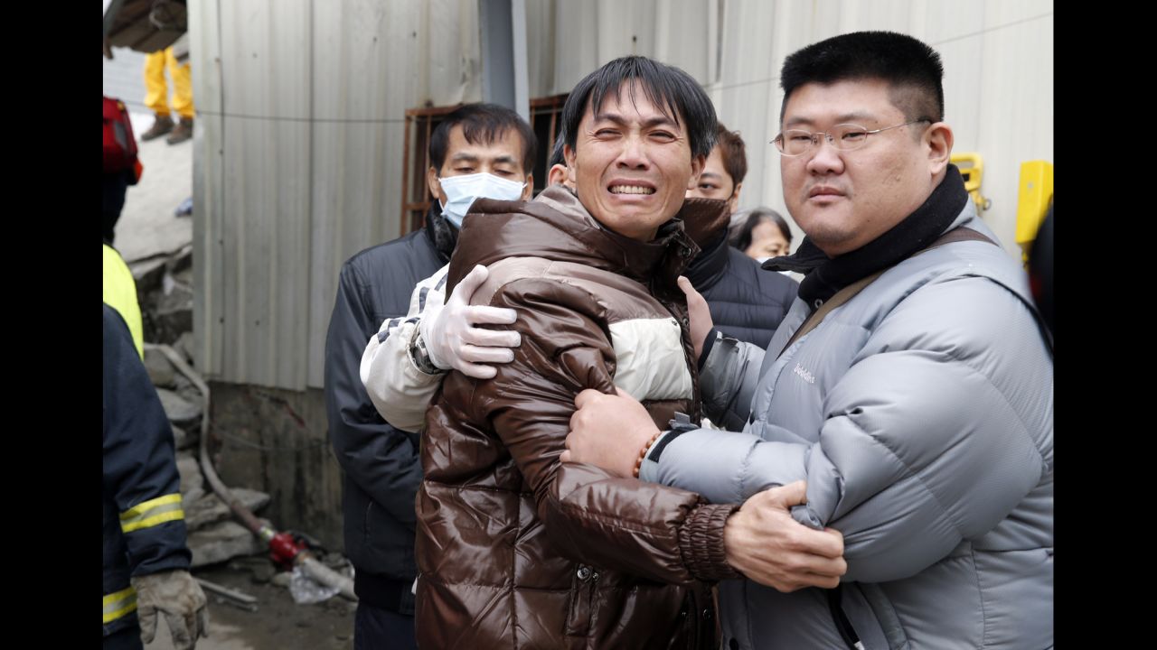 A man breaks down after seeing the body of a relative recovered from a collapsed building in Tainan.