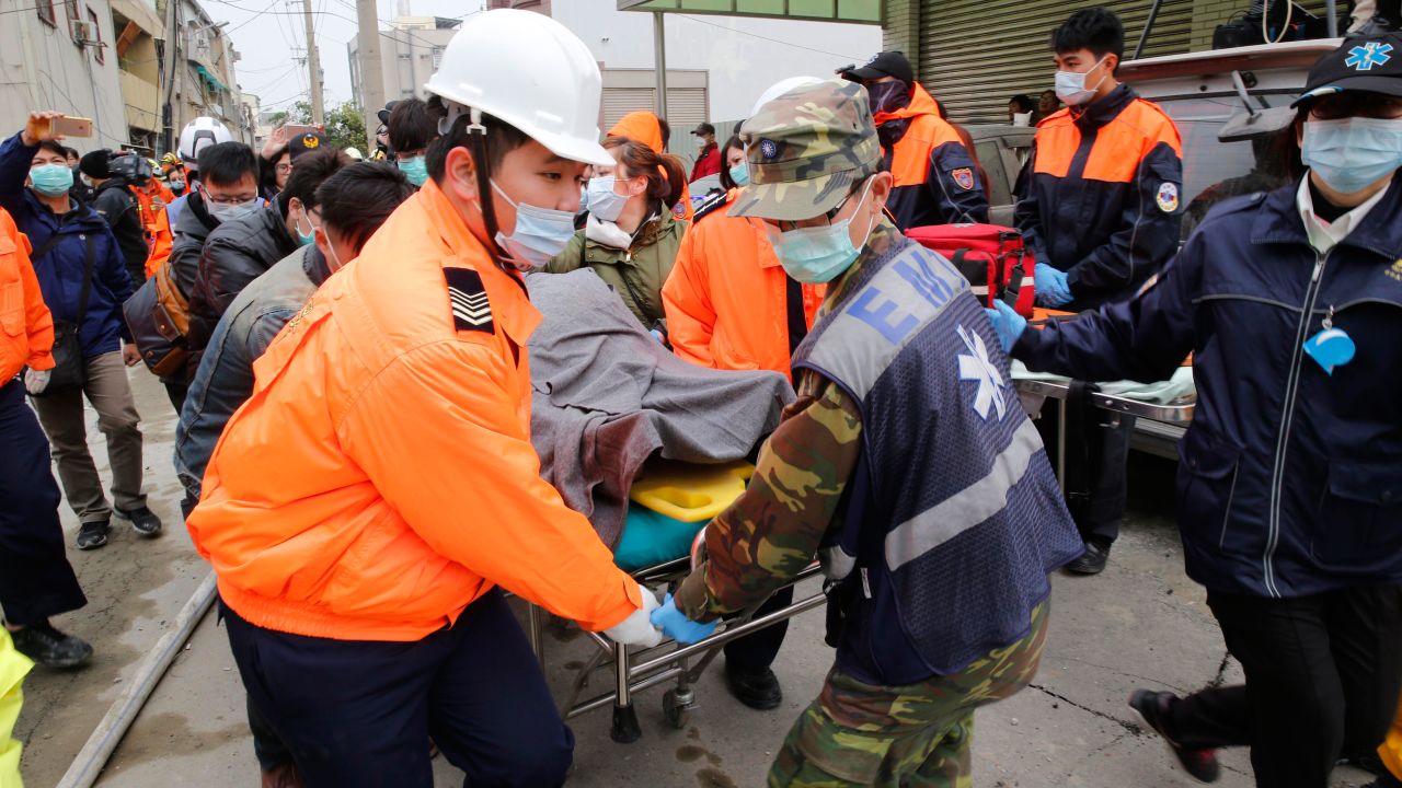 Rescue workers remove a victim on a stretcher in Tainan.